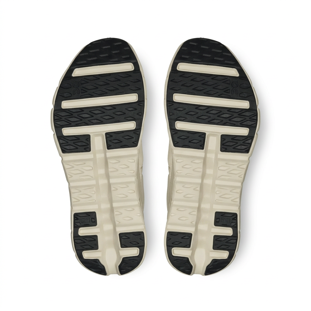 On Cloudtilt ivory and black outsoles, bottom view on white