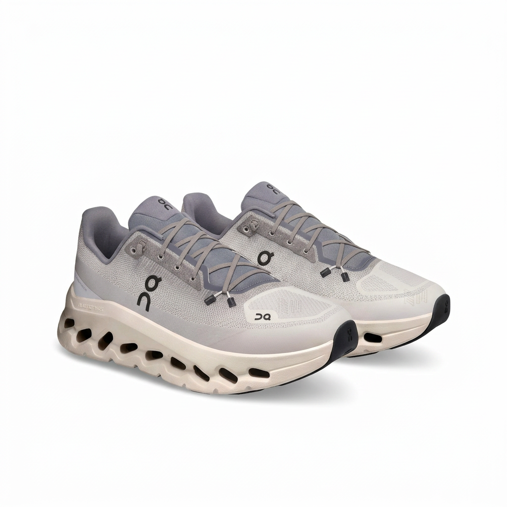 On Cloudtilt light grey and ivory sneakers, pair in three-quarter view on a white background