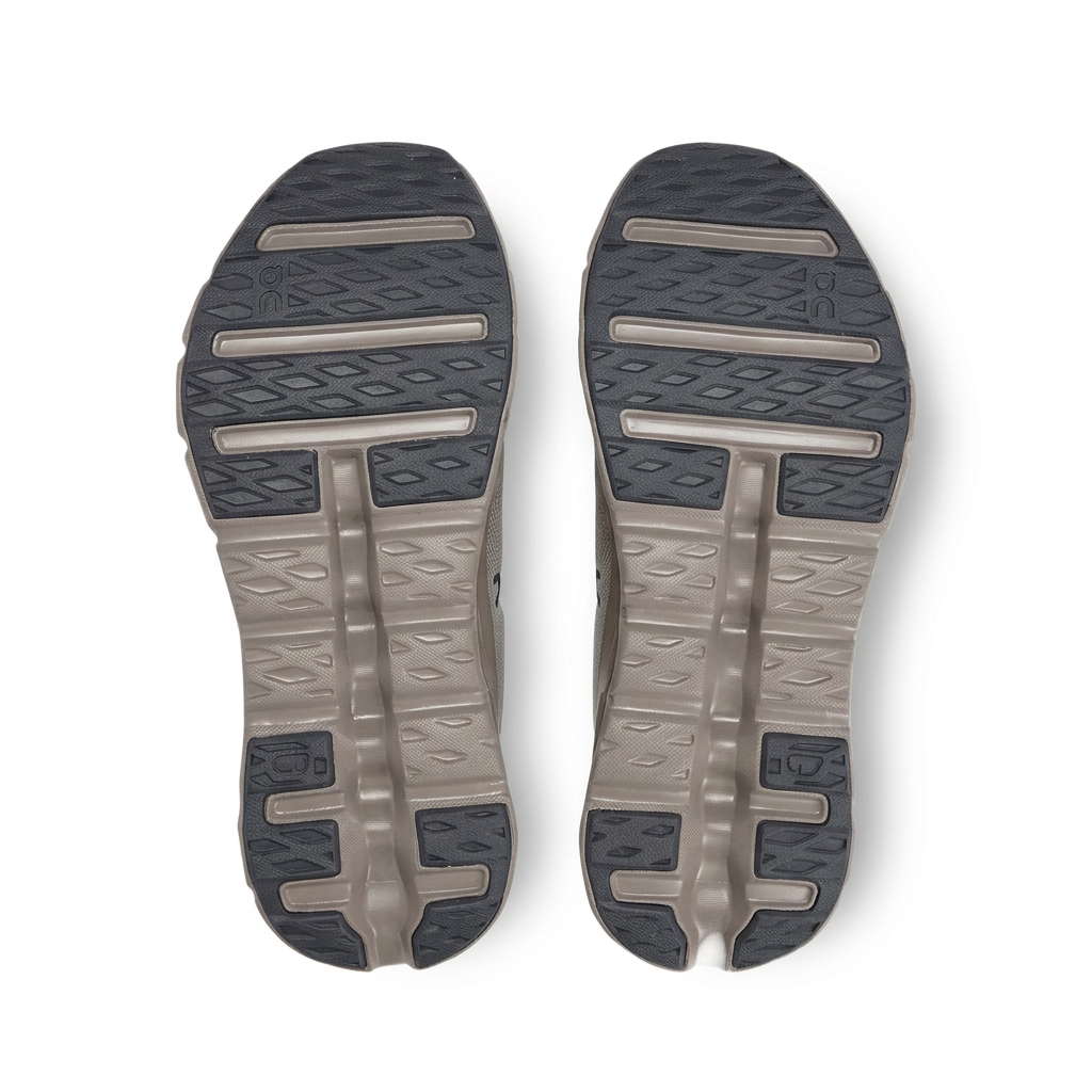 Taupe and charcoal On Cloudtilt outsoles on white background
